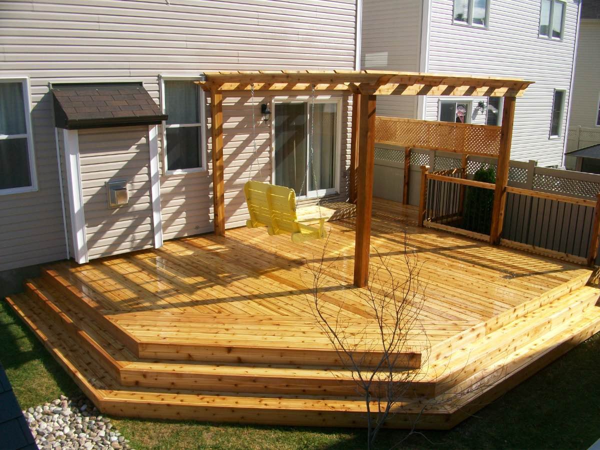 Cedar deck with a pergola and bench seating in afternoon sun