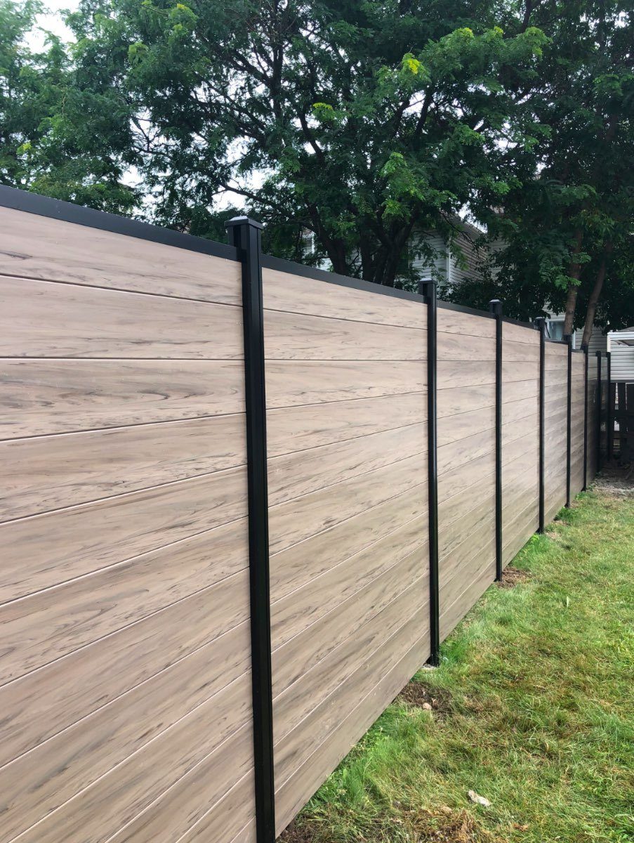 Driftwood-tone horizontal composite privacy fence with black posts