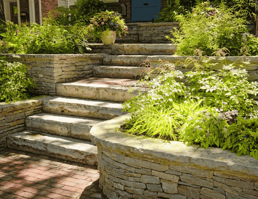 Natural stone retaining walls and steps with lush garden planting